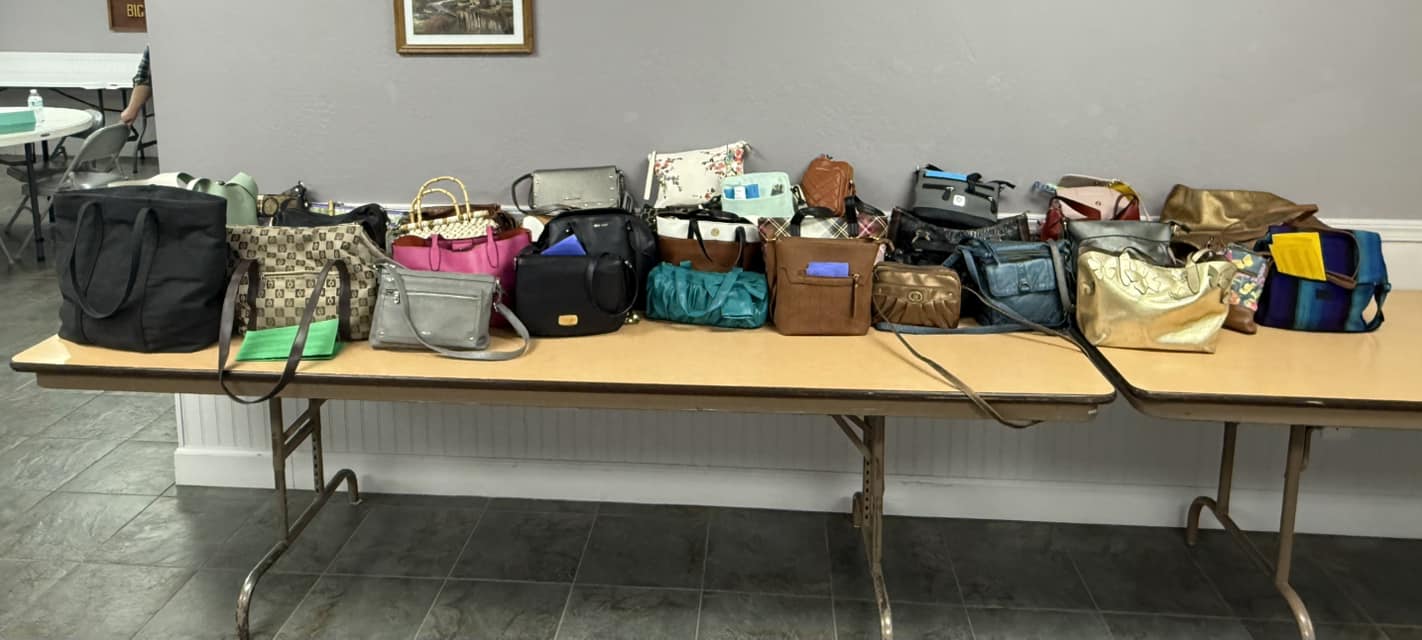 A table covered in purses